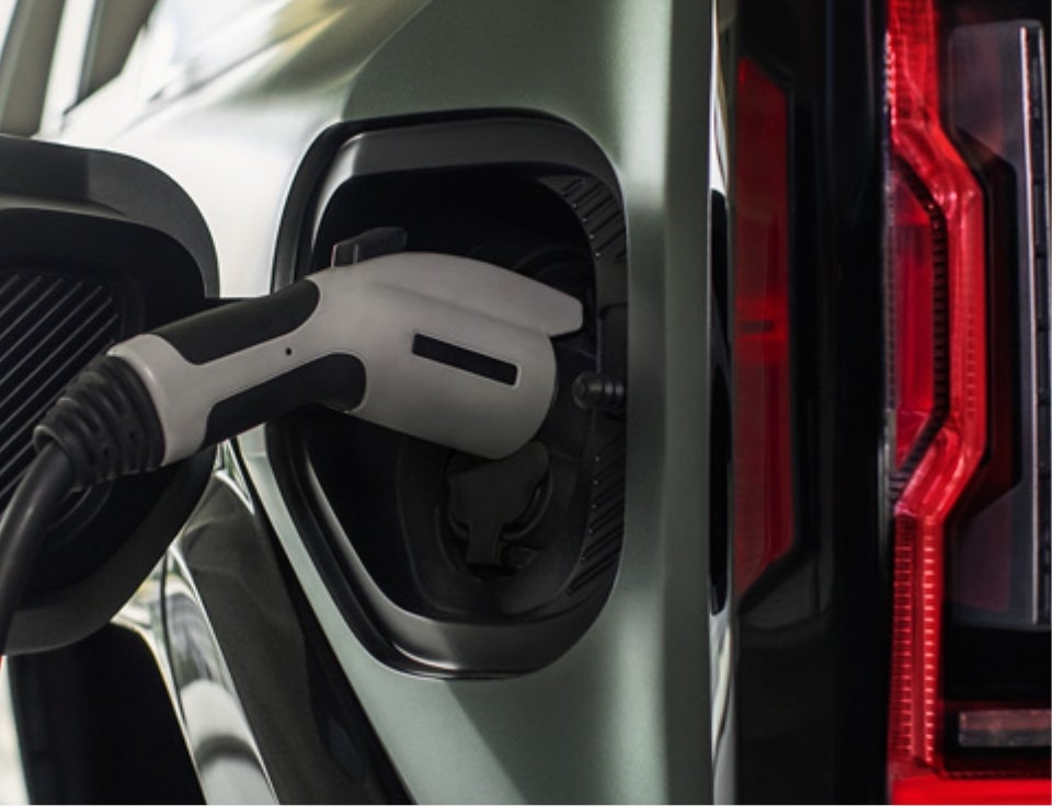 Close up of charging port with charger plugged in on a GMC Hummer EV SUV - Joe Ball GMC in Glenshaw PA